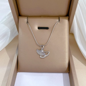 Close-up of a silver ginkgo leaf pendant necklace in a luxury jewelry gift box
