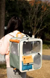 Outdoor model shot of a colorful cat carrier backpack with breathable mesh and side pockets