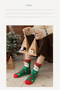 Close-up of green Christmas socks with Santa patterns and a creative gift box