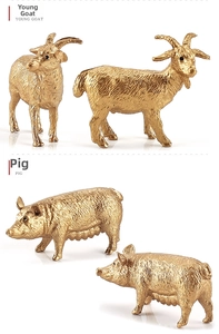 Detail view of miniature gold-plated goat and pig figurines with intricate textures
