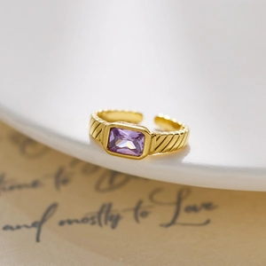 Close-up of a vintage 18k gold-plated ring featuring a rectangular purple crystal