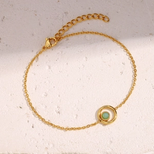 Detail of 18K gold plated stainless steel bracelet with a green stone pendant and lobster clasp