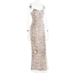 Close-up of white lace dress featuring a gold chain belt and intricate floral patterns