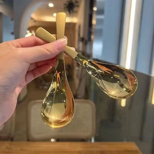 Polished golden stainless steel dessert spoons with modern minimalist design