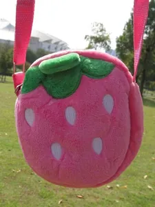 Pink plush strawberry crossbody bag for kids with green leaf top and embroidered details