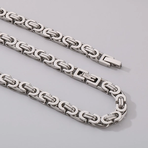 Detail of silver Byzantine chain structure and stainless steel lobster clasp engraving