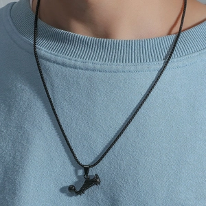 Detailed view of hip hop soccer shoe pendant with box chain on male model neck
