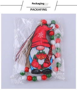 Close-up of a Christmas gnome wood pendant with red, green, and white beads in packaging