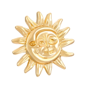 Close-up of golden sun and moon face jewelry with high-polished relief texture