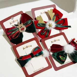 Velvet Christmas bow hair clips set with reindeer, tree, and sequin antler details