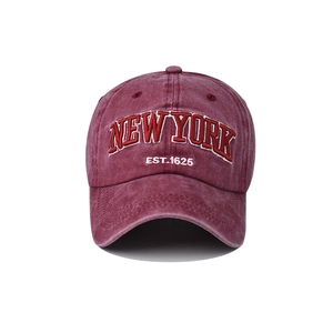 Detail of premium New York 3D embroidery on washed burgundy cotton baseball cap