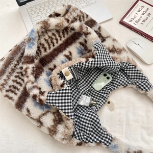 Interior view of fuzzy tote bag showing plaid lining, snap button and spacious compartment