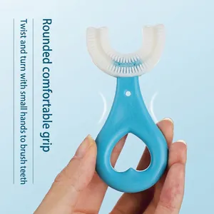 U-shaped manual toothbrush for kids with soft blue silicone head and heart grip