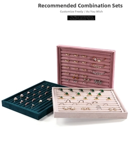 Detailed view of velvet jewelry display trays in green, pink, and grey for rings and earrings