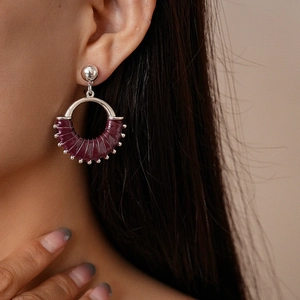 Close-up of geometric silver ring earrings wrapped in vintage burgundy leather for women