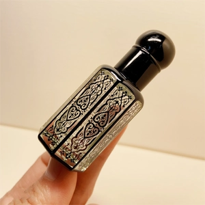 Laser-coated square crystal essential oil bottle with black patterns and dropper cap