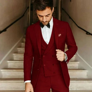 Detailed shot of slim fit burgundy three-piece tuxedo with double-breasted vest for men