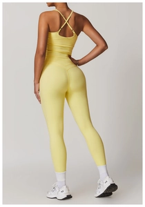 Close-up of criss-cross back yoga vest and high-waisted leggings in pale yellow fabric