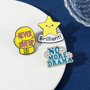 Detailed view of enamel pins featuring boxer gloves and stars on a white decorative plate