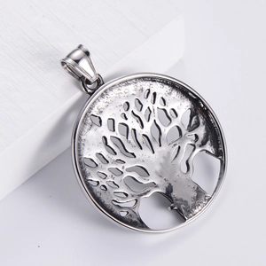 Vintage Tree of Life pendant in stainless steel displayed on a white geometric stone base