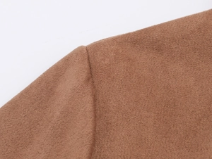 Detailed macro view showing the high-quality suede fabric texture and shoulder stitching