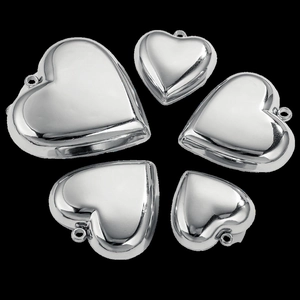 Polished silver heart pendants in five sizes displayed on a professional black background
