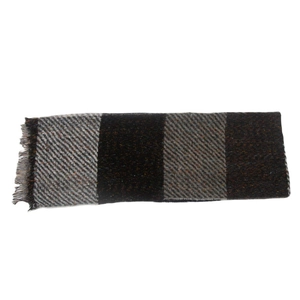 Detail of soft gray and black plaid scarf with classic fringed edges and thick twill texture