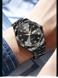 Close-up of OLEVS quartz watch featuring day-date display and black metal strap