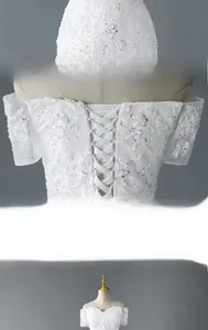 Detail of elegant lace bridal gown showing waist cinching and adjustable back lace-up