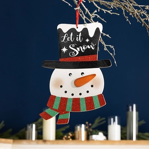 Christmas snowman hanging ornament with Let it Snow text on a winter branch background