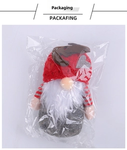 Christmas gnome plush in packaging with reindeer antlers and white beard detail