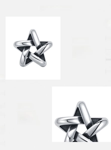 Macro detail of s925 sterling silver hollow star earring with a polished vintage finish