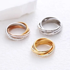 Three-tone interlocking band rings in gold, silver and rose gold with zircon inlay