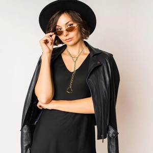 Gothic Cuban chain necklace with gold heart lock pendant worn over black leather outfit
