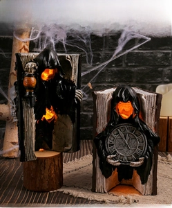Detailed view of Halloween resin reaper figurines with glowing lanterns on retro book bases