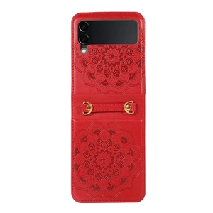 Detail of red leather case with embossed mandala pattern and gold hardware strap
