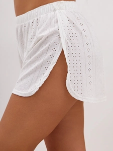 Detail of white eyelet lace pajama shorts with floral embroidery and side slits