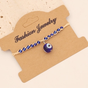 Bohemian evil eye beaded bracelet with blue charms on fashion jewelry display card