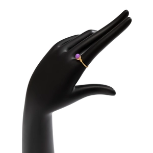 Detail of handmade gold wire-wrapped open ring with raw purple amethyst crystal stone