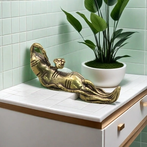 Artistic golden brass leopard sculpture with brushed metal texture on white counter