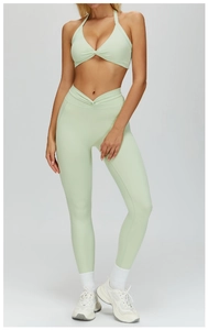 Detail of mint green yoga set with twist front bra and V-waist high-stretch leggings