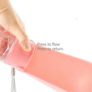 Pink portable dog water bottle with one-hand operation button for outdoor feeding