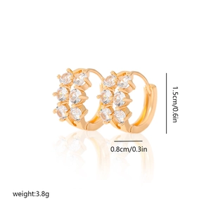Detail view of gold zircon hoop earrings with 1.5cm diameter and 0.8cm width dimensions