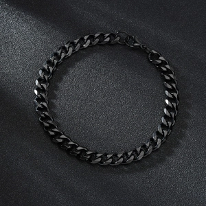 Detail shot of a black stainless steel Cuban link bracelet with a polished industrial finish