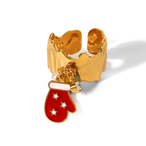 Detail view of golden wave ring with red glove charm, white star, pearl and zircon