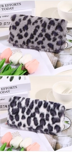Detailed view of plush leopard print pouches in grey and white faux fur textures