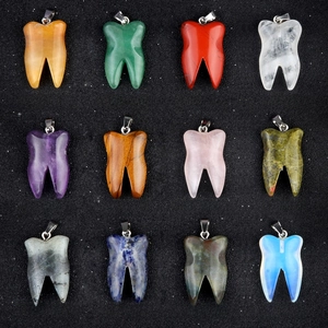 Set of 12 natural crystal tooth-shaped stone pendants with metal bails on black background