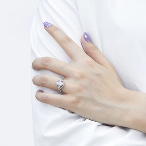 Close-up of elegant oval zircon ring with pavé setting and twisted band on a hand