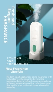 Detail of white smart fragrance diffuser showing power button and visible aromatic mist