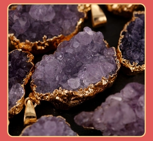 Macro view of natural purple amethyst crystal cluster pendant with gold plated metal edge